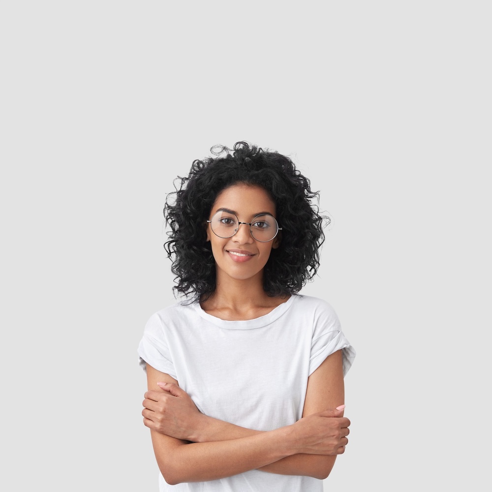 vertical shot happy dark skinned female with curly hair